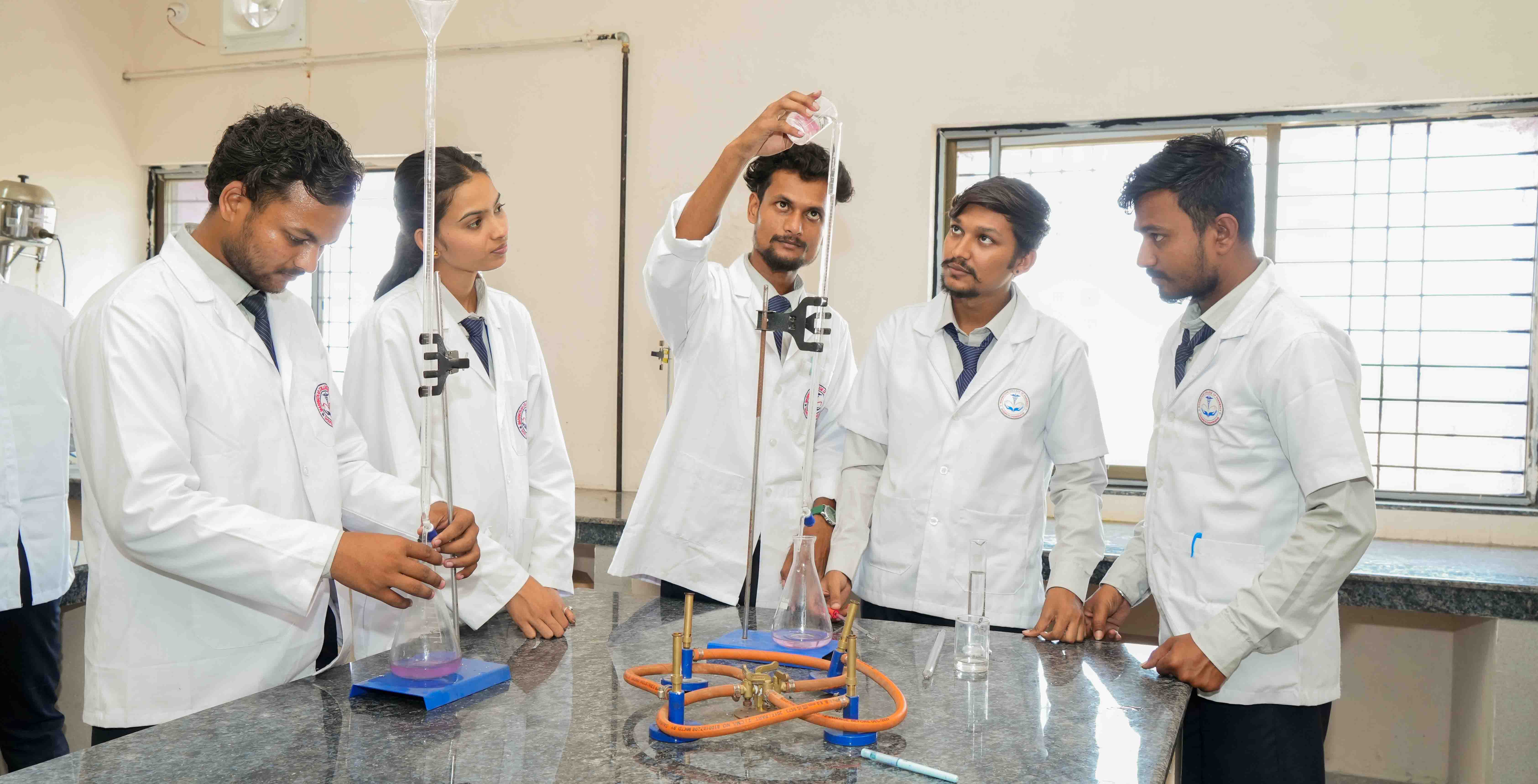 Students performing experiments in the pharmacy laboratory at Manwatkar College of Pharmacy